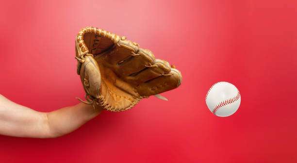 The baseball glove hand catches a ball.