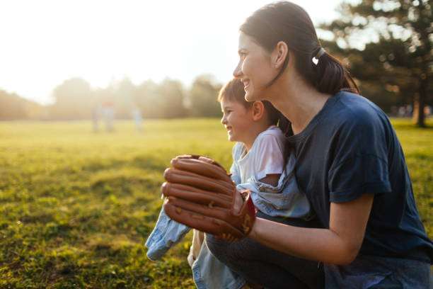 Mother and son playing baseball glove