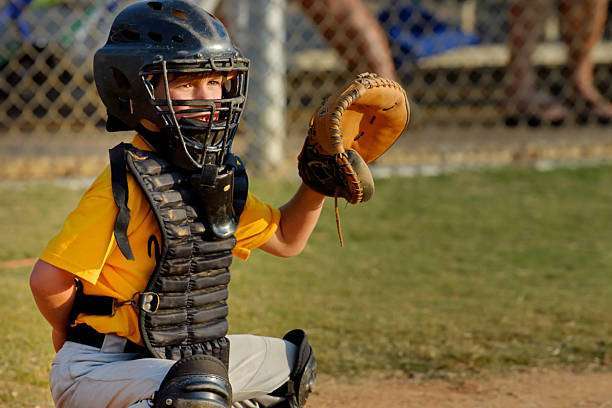 A female baseball glove hand catches a ball.