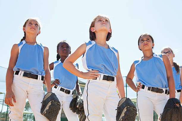 A female baseball glove hand catches a ball.
