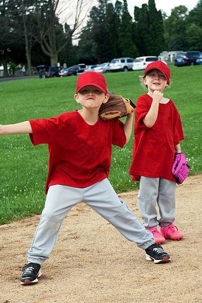 a young boy wearing baseball glove