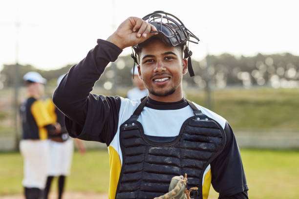 Portrait of a handsome young baseball player with a baseball glove