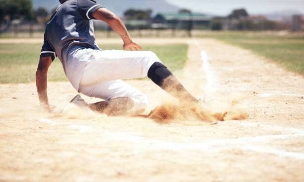 Person swinging a bat at a baseball on a sunny field, ready for their baseball glove.