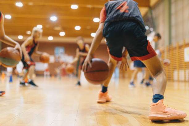 Young athletes enjoy basketball practice, a stark contrast to catching with a baseball glove.